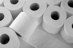 several rolls of toilet paper are stacked on top of each other in black and white