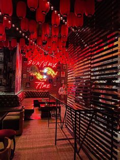 a restaurant with red lanterns hanging from the ceiling