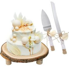 there is a cake with flowers on it next to a knife and fork set up