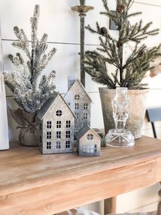 three small houses sitting on top of a wooden table