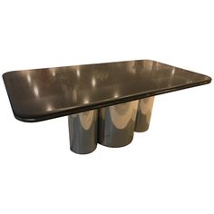 the table is made out of metal and has three rolls of paper on top of it