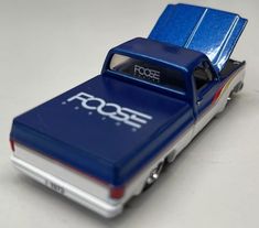 a toy truck that is blue and white with the word foose on it's side