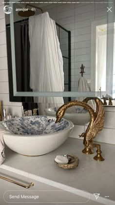 a bathroom sink sitting under a mirror next to a towel rack