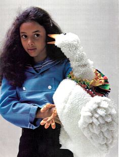 a woman holding a stuffed animal in her arms