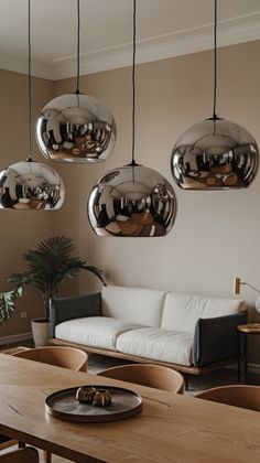 a living room filled with furniture and hanging lights