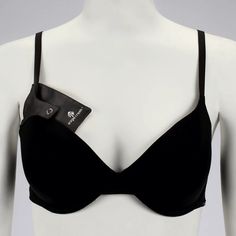 a woman wearing a black bra with a tag on it