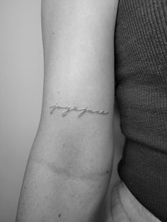 a woman's arm with the word love written in cursive writing on it