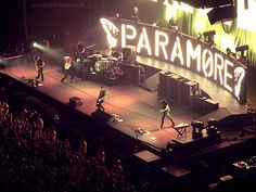 the band paramored performing on stage in front of an audience at a concert