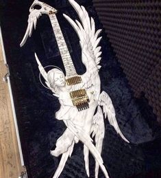 a sculpture of an angel holding a guitar