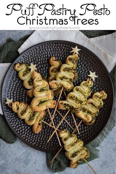 an image of christmas treats on a plate with the title text overlay that reads puff pastry pesto christmas trees