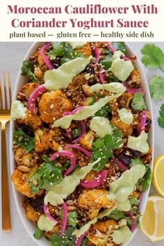 a white bowl filled with cauliflower, red onions and cilantro dressing