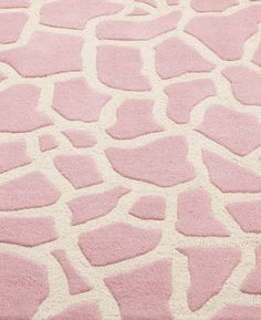 a pink and white rug with an animal print pattern