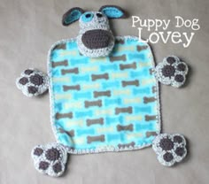 a stuffed animal with paws on it's chest and the words puppy dog lovey written below