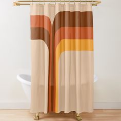 a shower curtain with an orange and brown design on the bottom, in front of a white bath tub