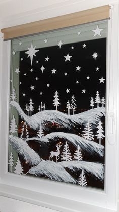 a window decorated with white stars and trees