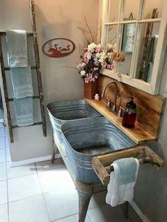 a bathroom with two sinks and towels hanging on the wall