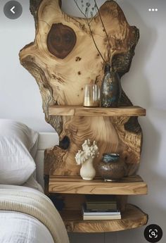 a wooden shelf with vases and books on it