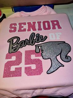 Perfect for all BARBIE lovers! The sweatshirts shown are examples of what you will get. Of course, it will be 24 instead of 23. This sweatshirt can be made with solid or glitter vinyl. OR both but we prefer glitter over anything✨ Leave a lasting impression with this beauty. The sweatshirts shown are examples of what you will get. Leave your desired color(s) in the note section at checkout. When will my product arrive? Processing Time: 15 - 20 Business Days During holidays, please expect delays as the number of orders is slightly higher than usual, although we will do our best to get your order to you as soon as possible. Shipping Time First Class shipping will take 2-5 Business Days Priority shipping will take 2-3 Business Days. If you need the items fast, please look up our RUSH FEES! Ret Senior Jeans Painted 2023 Pink, Barbie Theme Senior Pictures, Diy Senior Sweatshirts Ideas, Senior Barbie, Senior Barbie Sweatshirt, Vinyl Sweatshirt Ideas, Senior Sweatshirts Ideas, Large Ponytail, Barbie Crewneck