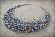 a circle made out of rocks on the sand