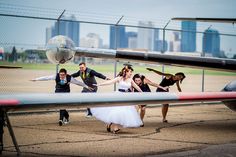 a group of people that are standing in front of a plane