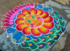 a colorful flower design painted on the ground