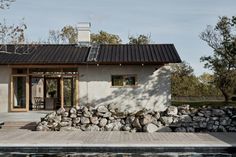 a small house with a pool in front of it