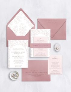 the wedding stationery is laid out on top of each other, including pink envelopes and