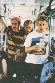 a group of young men riding on top of a bus