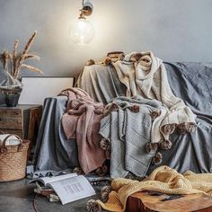 blankets and other items on the floor in front of a lamp, with a light bulb above them