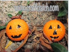 two pumpkins with faces carved into them sitting on the ground next to some leaves