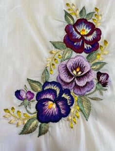 an embroidered piece of cloth with flowers on it