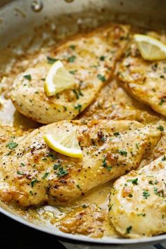 chicken with lemons and herbs cooking in a skillet