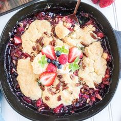 a skillet filled with fruit and ice cream