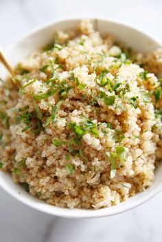 a white bowl filled with rice and green onions