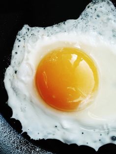 an egg is fried in a frying pan