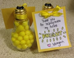 there is a jar with yellow candies in it and a note attached to the bottle