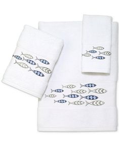 two white towels with blue fish on them