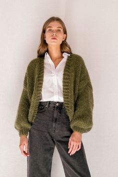 "The Mohair Bomber Cardigan -- hand knitted in fluffy kid mohair that feels like being wrapped in a soft, puffy cloud. Designed to flatter all silhouettes with its wide oversized fit, slightly cropped length and voluminous balloon sleeves. Comes in 8 versatile colors, carefully chosen to match all wardrobe color palettes. Handcrafted in Greece. DETAILS * Super soft, premium quality Italian mohair * Composition: 60% kid mohair, 40% microfiber * Hand wash in cold water SIZE & FIT * Wide fit, cropp Handmade Mohair Cozy Cardigan, Green Mohair Winter Cardigan, Hand Knitted Mohair Cardigan, Hand Knitted Mohair Outerwear, Cozy Hand Knitted Mohair Cardigan, Hand Knitted Mohair Cardigan For Winter, Cozy Mohair Knitted Cardigan, Cozy Knitted Mohair Cardigan, Cozy Fall Mohair Knitting Pattern