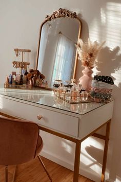 a dressing table with a mirror and various items on it