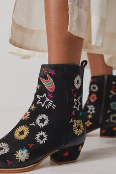 A sleek, ankle length style gets a playful makeover with these doodle-adorned ankle boots. Suede fabrication, pointed toe, stacked block heel, pull tabs, inner ankle zipper, doodle embroidery throughout Perfect for adding a quirky touch to any look. Doodle Embroidery, Quirky Shoes, Free People Boots, Tall Heeled Boots, Boot Design, Embroidered Boots, Pink Fits, Free People Shoes, Leather Block Heels