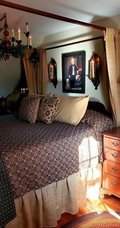 a bedroom with a bed, dresser and pictures hanging on the wall above it's headboard