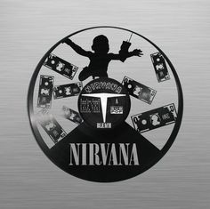 the logo for nirvana is surrounded by many stickers and magnets on a metal surface