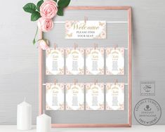 a pink rose is next to a wooden frame with seating cards and candles on it