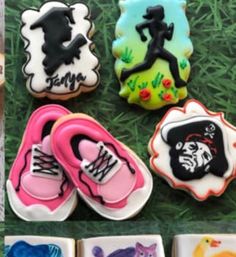 there are many decorated cookies on the grass