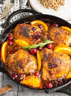 cranberry orange chicken thighs in a cast iron skillet