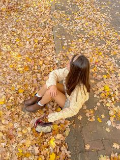 a woman sitting on the ground with her legs crossed