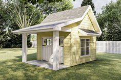 a small yellow shed sitting on top of a lush green field next to a white picket fence