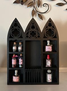 three black shelves with bottles and spices on them