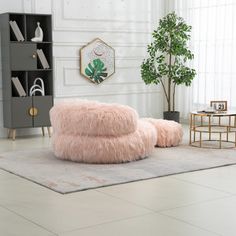 a living room filled with furniture and a pink fur covered bean bag on top of a rug