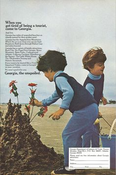 two young boys are playing in the sand with flowers and plants that grow out of them